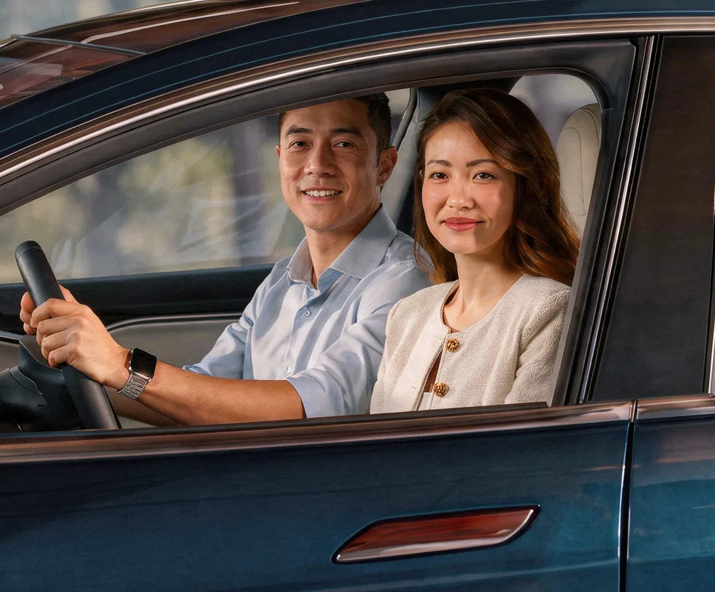 People smiling from inside a car